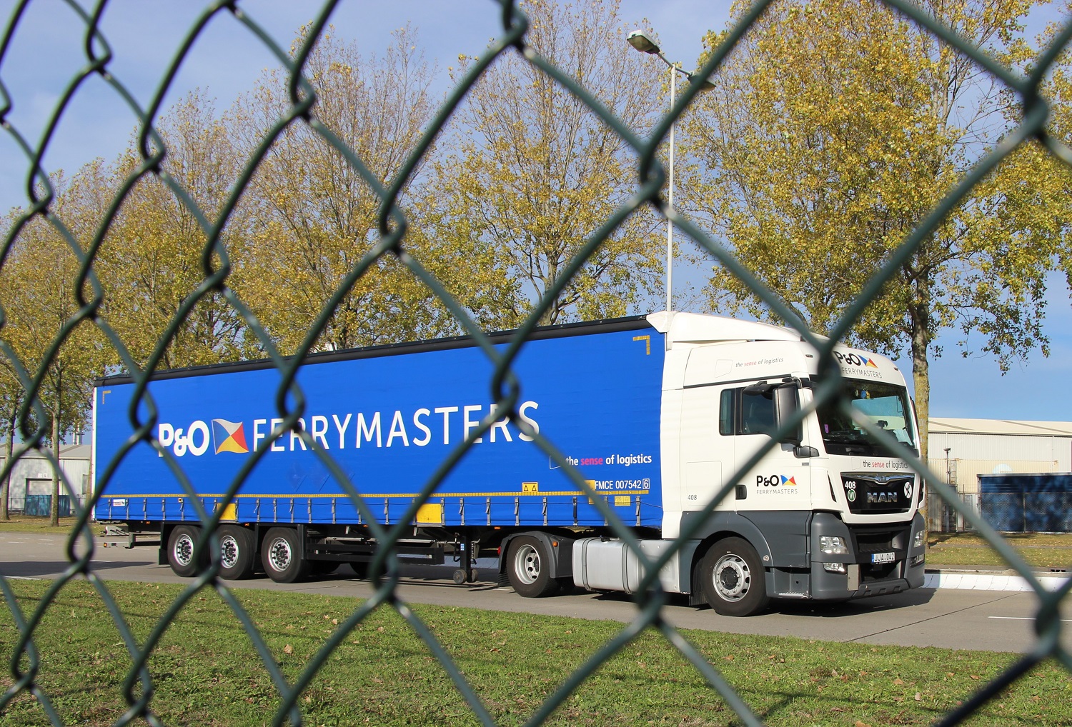 logistics truck behind fence zoomed in IMG_1269